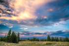 USA, Wyoming, Medicine Bow National Forest. Sunrise clouds over mountain and forest landscape. Art Print